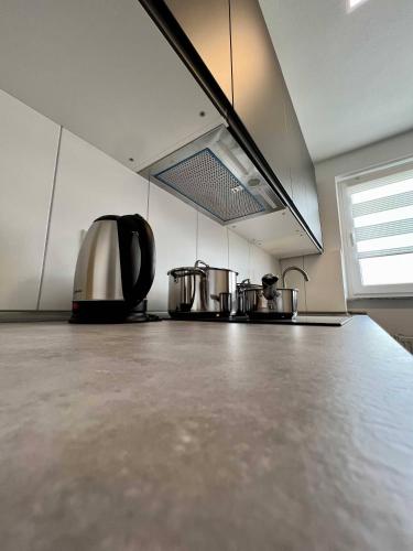 a kitchen with two pots and a stove at Nujen- Hotel und Apartment Stuttgart Zuffenhausen in Stuttgart