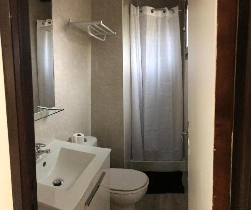 a bathroom with a sink and a toilet and a shower at Camping Trinité in Bonifacio