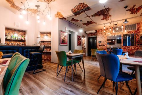 a restaurant with tables and chairs and a bar at Hotel Ambiente Wellness & Spa in Karlovy Vary