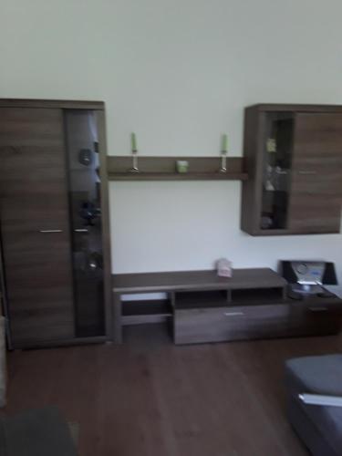 a room with a kitchen with wooden cabinets at Ferienwohnung Rote-Villa 2 in Marienberg