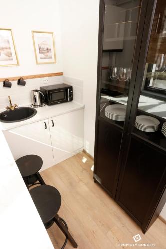 a kitchen with a sink and a microwave at Chic Concept Studio in Bucharest