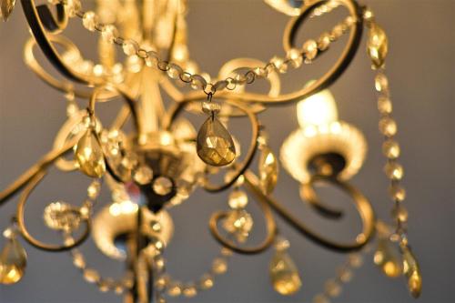 a close up of a gold chandelier at Peaceful & Pretty 2 bedroom flat near Clifton in Bristol
