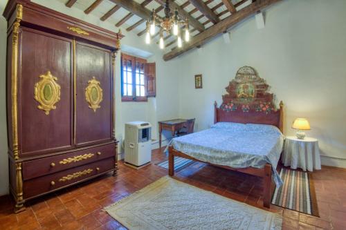 a bedroom with a bed and a large dresser at Canapost in Peratallada