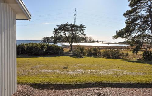 a yard with a view of the ocean from a house at Amazing Home In Rockneby With Wifi in Rockneby