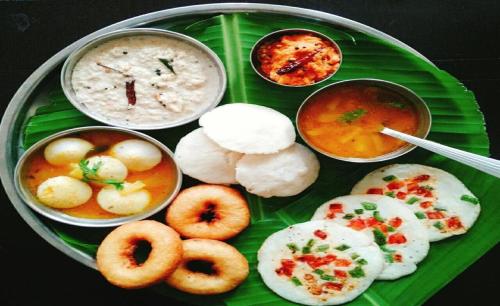 a plate of food on top of a green plate at HOTEL J K REGENCY in Mumbai