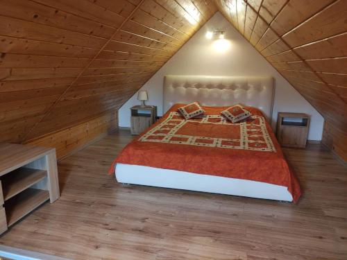 a bedroom with a large bed in a attic at AsPa in Ostrowo