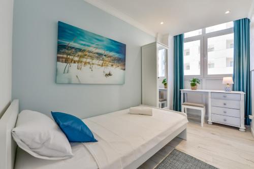 een slaapkamer met een bed en een schilderij aan de muur bij Apartment EntreDosAguas in Calpe