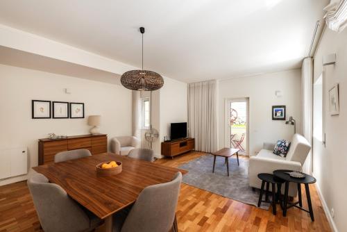 a living room with a wooden table and a dining room at Bombarda Homes in Porto