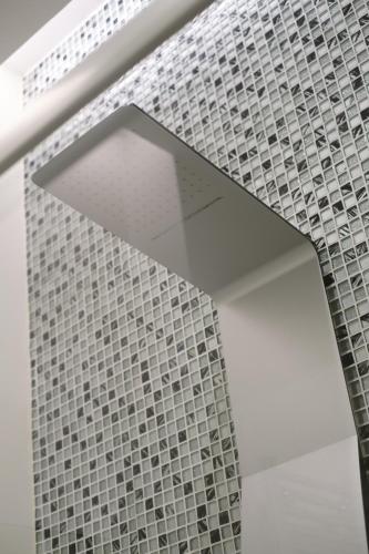 a room with a wall of tiles on the wall at Domea Superior Rooms Bed and Breakfast in Reggio Calabria