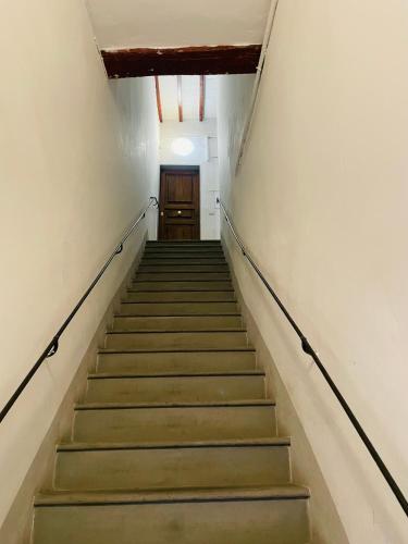 a flight of stairs in a building with a door at Ramaglianti Apartments Suite Tre in Florence
