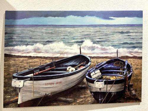 a painting of two boats on the beach at Souterrainwohnung - Remseck am Neckar in Remseck-Pattonville