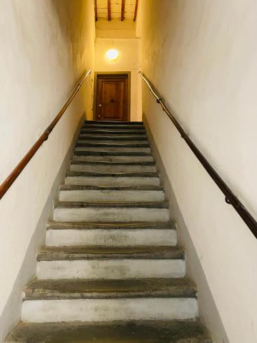 a staircase in an old building with a door at Ramaglianti Apartments Suite Tre in Florence