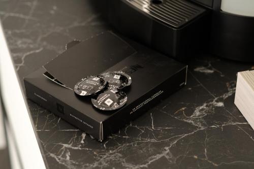 two watches sitting on top of a black box on a counter at Domea Superior Rooms Bed and Breakfast in Reggio Calabria