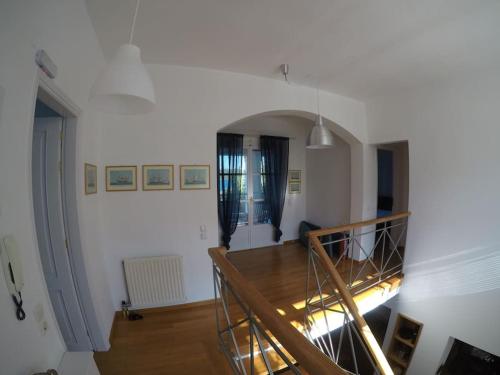 a living room with a staircase and a room with a stair case at Villa Liana in Soúrpi