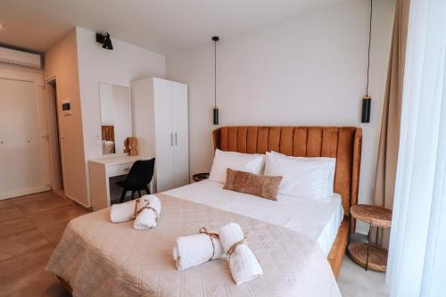 a bedroom with a bed with towels on it at Sithon Diamond Suites 2 in Nikiti