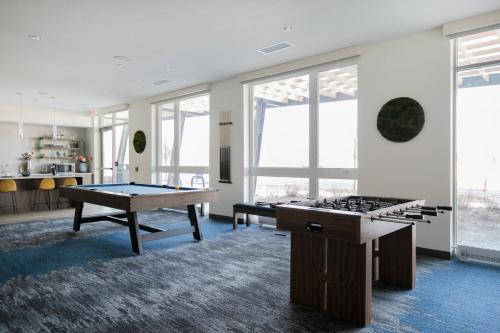 a living room with two ping pong tables in it at Arlington Heights 2br w wd gym bbq nr dining CHI-911 in Arlington Heights