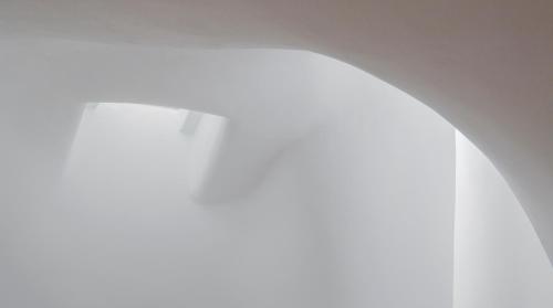 a close up of a woman wearing a white dress at AQUA SERENITY LUXURY SUITES SANTORINI in Foinikiá