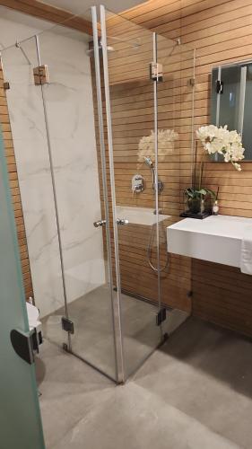 a bathroom with a shower and a sink at H7 TLV in Tel Aviv