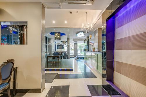 a hallway with a dining room and a kitchen with purple lighting at London Star Hotel in London