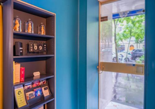 a room with a blue wall and a door at Nouvel Hôtel in Paris