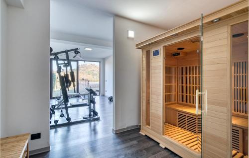 a gymnasium with a large wooden closet and a gym with a treadmill at Villa Del Borgo in Marano Marchesato