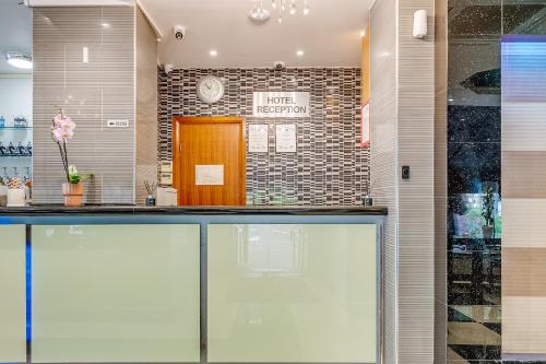 a lobby of a hotel with a reception counter at London Star Hotel in London