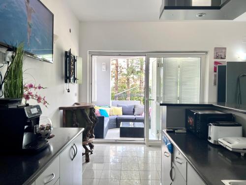 a kitchen with a living room with a couch at Apartments Ana & Ita in Novalja