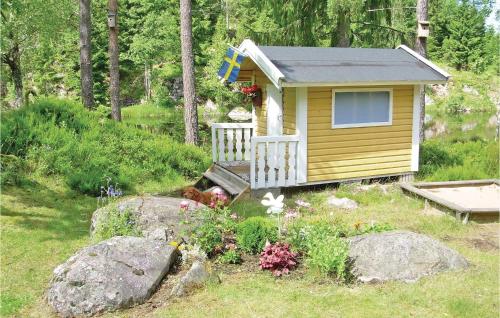 a small house with a flag on it in a yard at Two-Bedroom Holiday Home In Tived in Tived