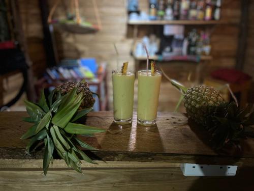 two glasses of pineapple juice on a wooden table at Meleji Studio House in Arusha
