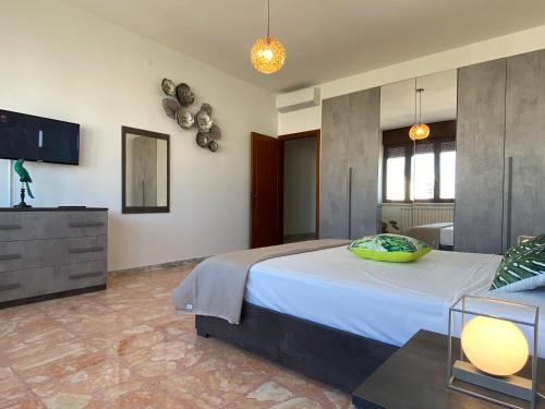 ein Schlafzimmer mit einem großen Bett und einem TV in der Unterkunft Tropical Apartment in Gallipoli