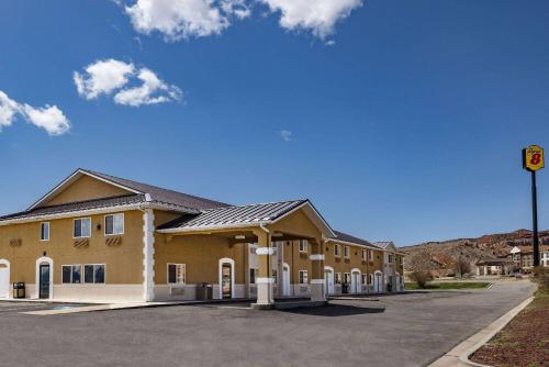 a large building with a parking lot in front of it at Super 8 by Wyndham Richfield UT in Richfield
