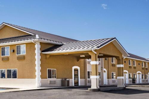 a large brown building with a black roof at Super 8 by Wyndham Richfield UT in Richfield