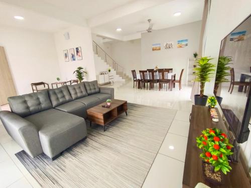 a living room with a couch and a table at Yarra Park, Up to 10 Pax, 5 Bedrooms, 4 Bathrooms, 2 Car Parks by Star Home in Sungai Petani