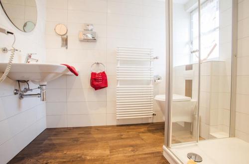 a white bathroom with a sink and a shower at Gasthof Hirsch in Gengenbach