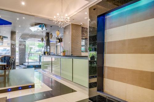 a kitchen with a glass counter and a chandelier at London Star Hotel in London