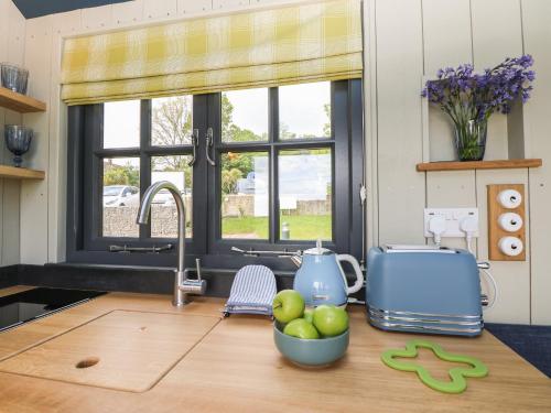 a kitchen with a sink and a bowl of apples on a counter at Malbec in Seaview