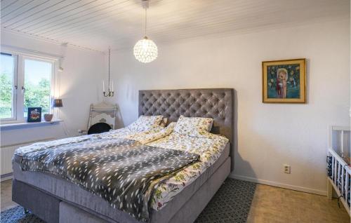 a bedroom with a large bed with a large headboard at Beautiful Home In Slite With Kitchen in Slite