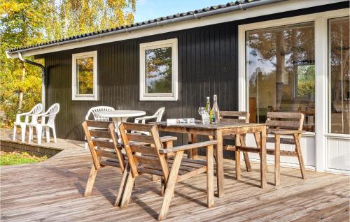 a wooden deck with a table and chairs at Holiday Home Græsted With Fireplace 02 in Græsted