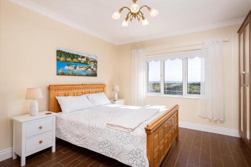 a bedroom with a bed and a window at Cottage 419 - Carna in Carna