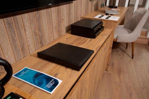 a desk with a book sitting on top of it at Days Inn by Wyndham Istanbul Arnavutkoy in Istanbul