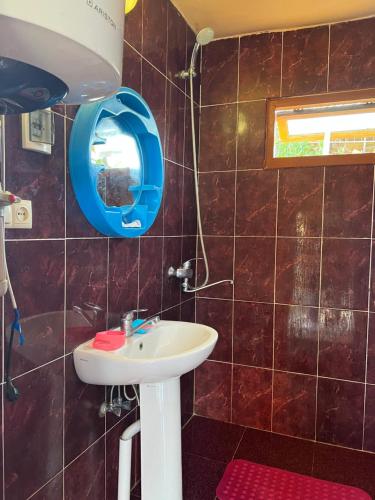 ein Bad mit einem Waschbecken und einem Spiegel in der Unterkunft NIKATOLO - HOTEL GUESTHOUSE 