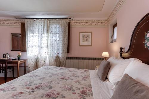 a bedroom with a large bed and a table at Agriturismo Nobile in Montepulciano