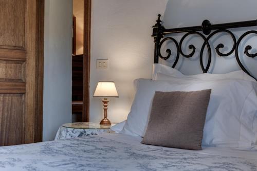 a bed with a pillow and a table with a lamp at Agriturismo Nobile in Montepulciano