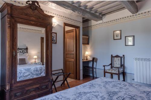 a bedroom with a bed and a large mirror at Agriturismo Nobile in Montepulciano