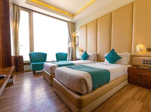 Ένα ή περισσότερα κρεβάτια σε δωμάτιο στο Hotel Millennium Inn, Prayagraj