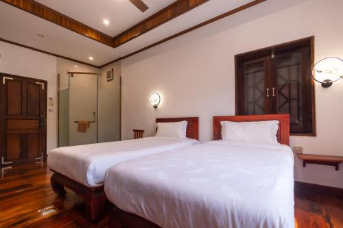 Postel nebo postele na pokoji v ubytování wisdom mystery Hotel
