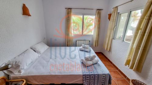 a bedroom with a bed with towels on it at CASA BACANA. MORAIRA- LIVE IT COSTABLANCA in Moraira