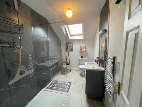 a bathroom with a shower and a sink and a toilet at Rosebank Apartment no 3 in Moville