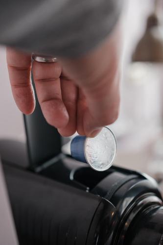 a person is holding a coin in a microscope at The Sanctuary House Hotel in London