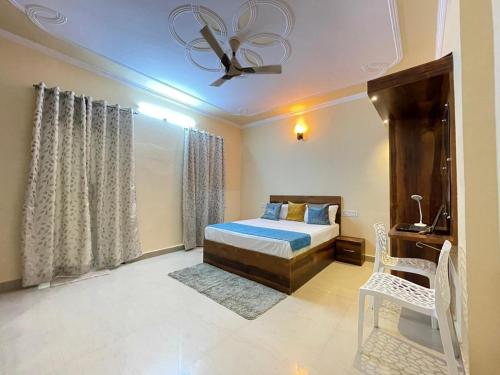 a bedroom with a bed and a ceiling fan at Visit Kashi Stay in Varanasi